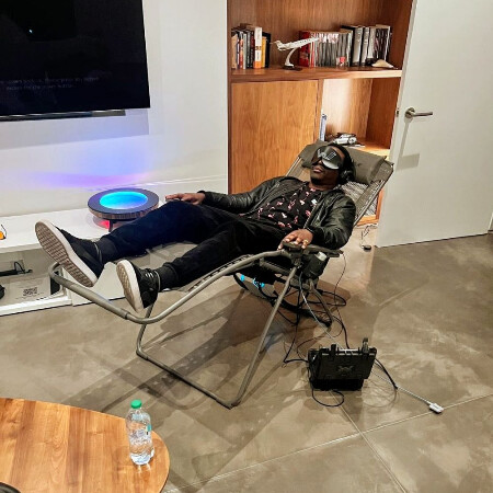 BW Simiyu wearing a VR headset, relaxing in a chair