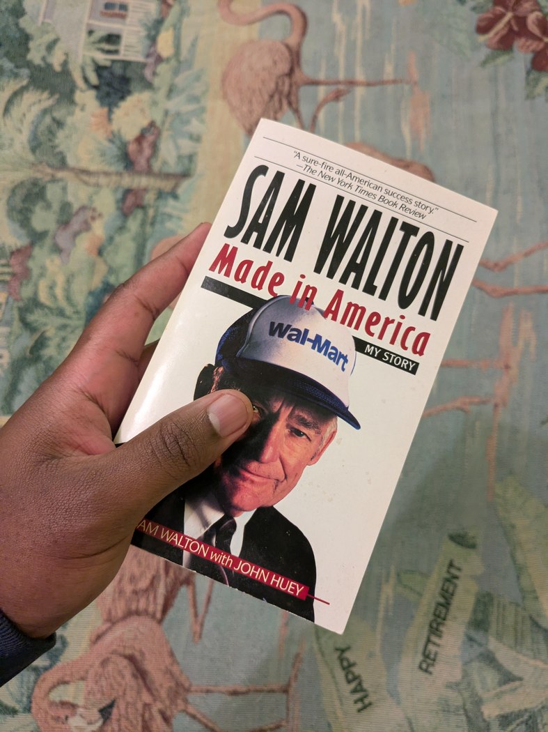 My copy of Sam Walton: Made in America, held against a patterned background
